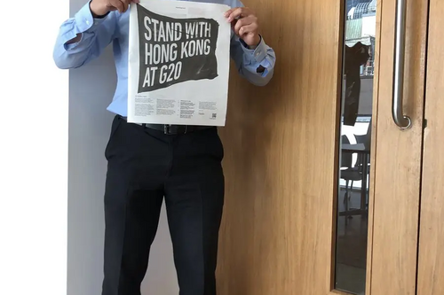 Larry Ngan holding Guardian Newspaper HK campaign