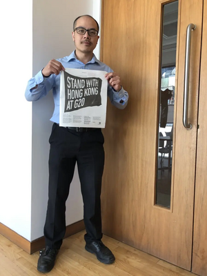 Larry Ngan holding Guardian Newspaper HK campaign